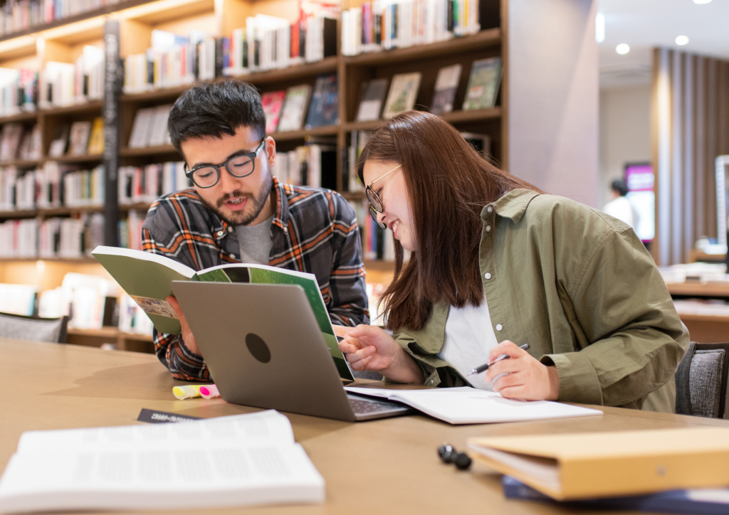 A man and woman looking at a book